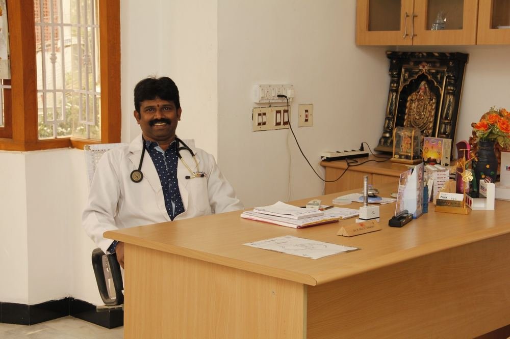 Dr. P. Muralidharan seated at his consultation desk