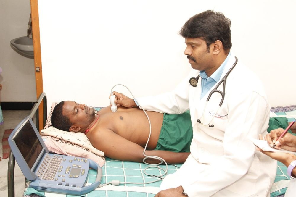 Dr. P. Muralidharan performing an ECHO cardiac ultrasound on a patient