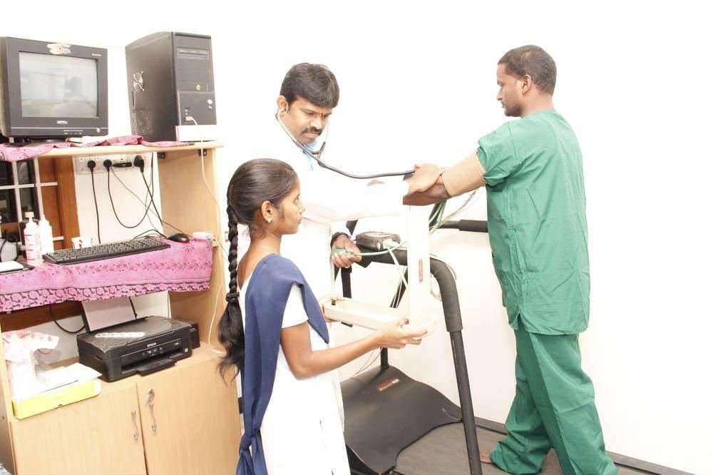 Close view of a treadmill stress test in progress with clinical staff